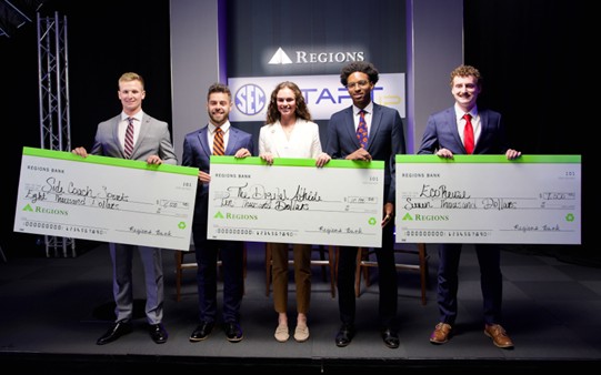 SideCoach on stage with the award check at the SEC pitch competition