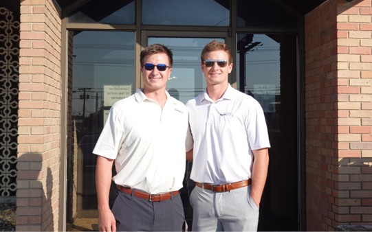 The SideCoach founders outside the company's office